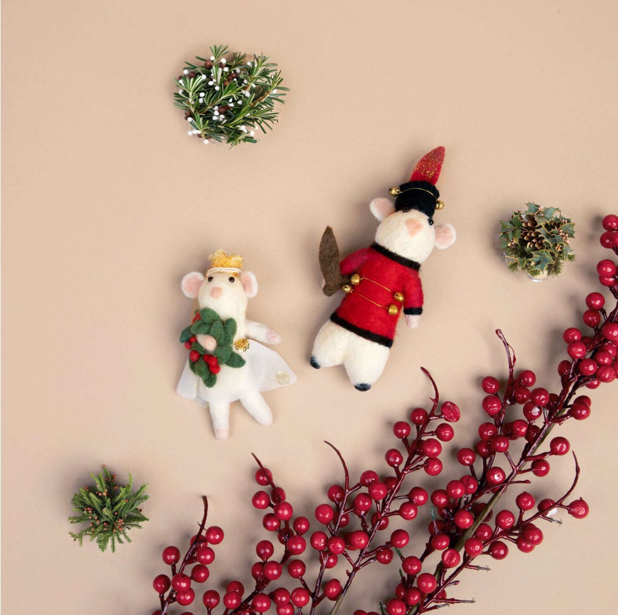 Felt Ballerina Mouse and Soldier Mouse ornaments on a beige background