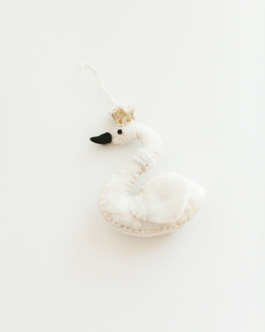 felt white princess swan with pearl necklace and gold crown hanging on a branch