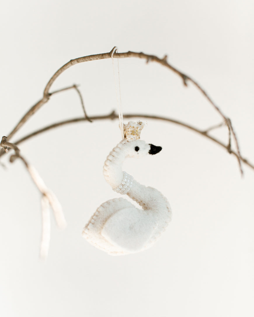 felt white princess swan with pearl necklace and gold crown hanging on a branch