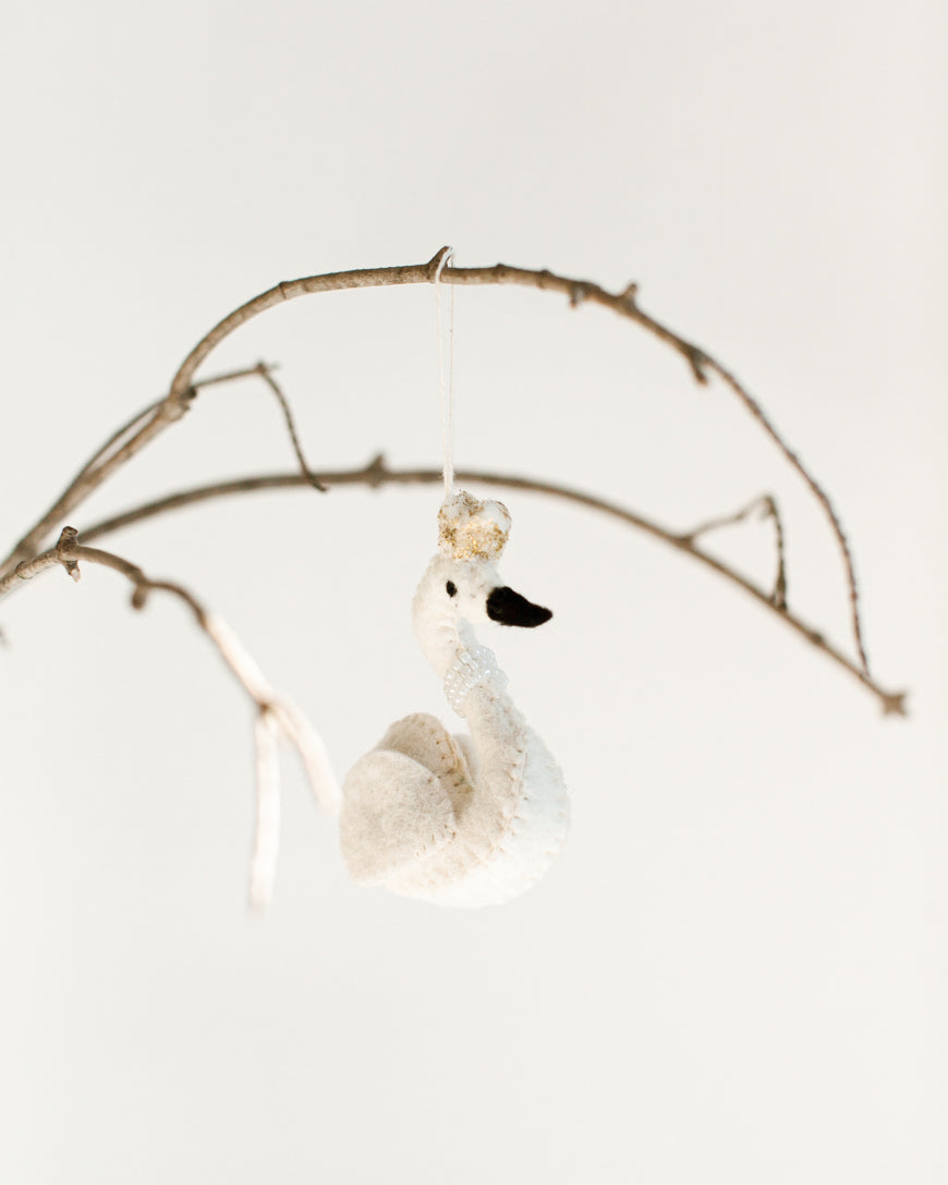 felt white princess swan with pearl necklace and gold crown hanging on a branch