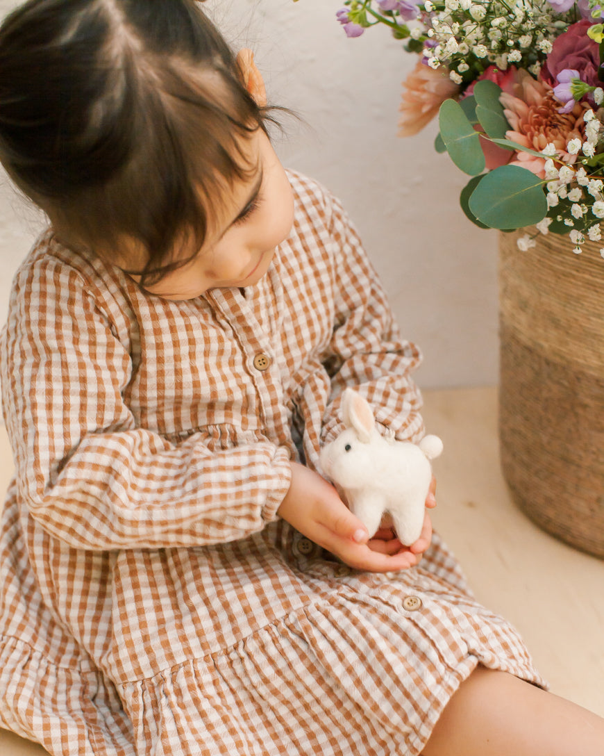 child holding white bunny ornament
